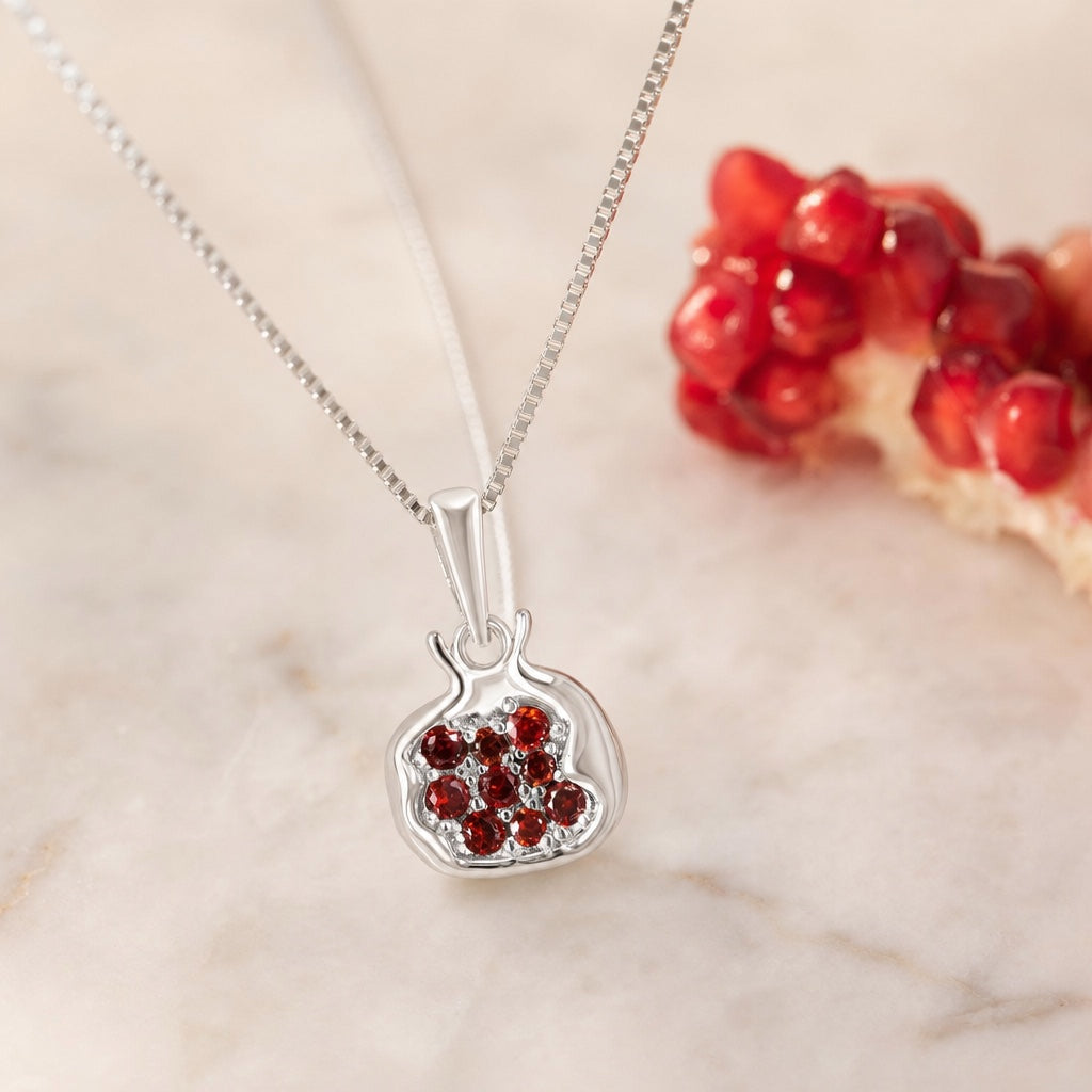 Pomegranate Necklace, editorial close-up on marble